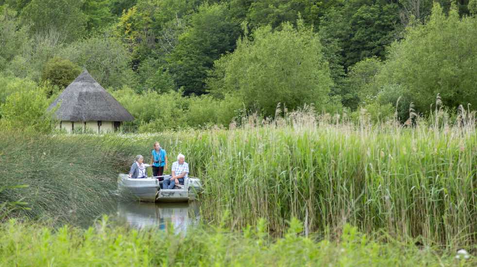 Three people boating on river